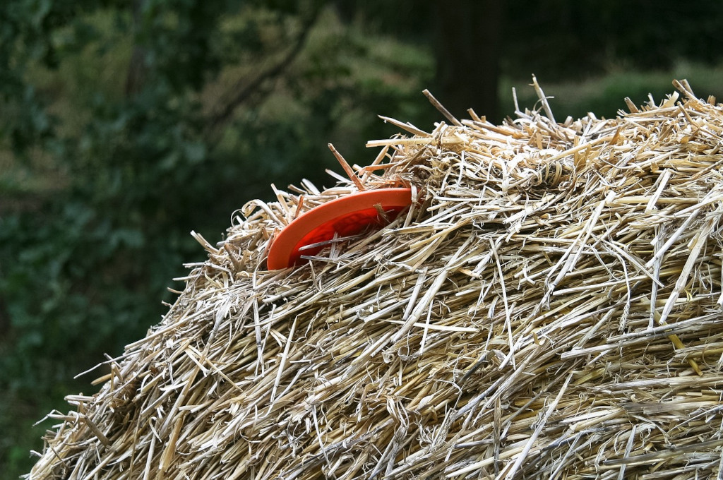 flying disc stuck in a hay bale